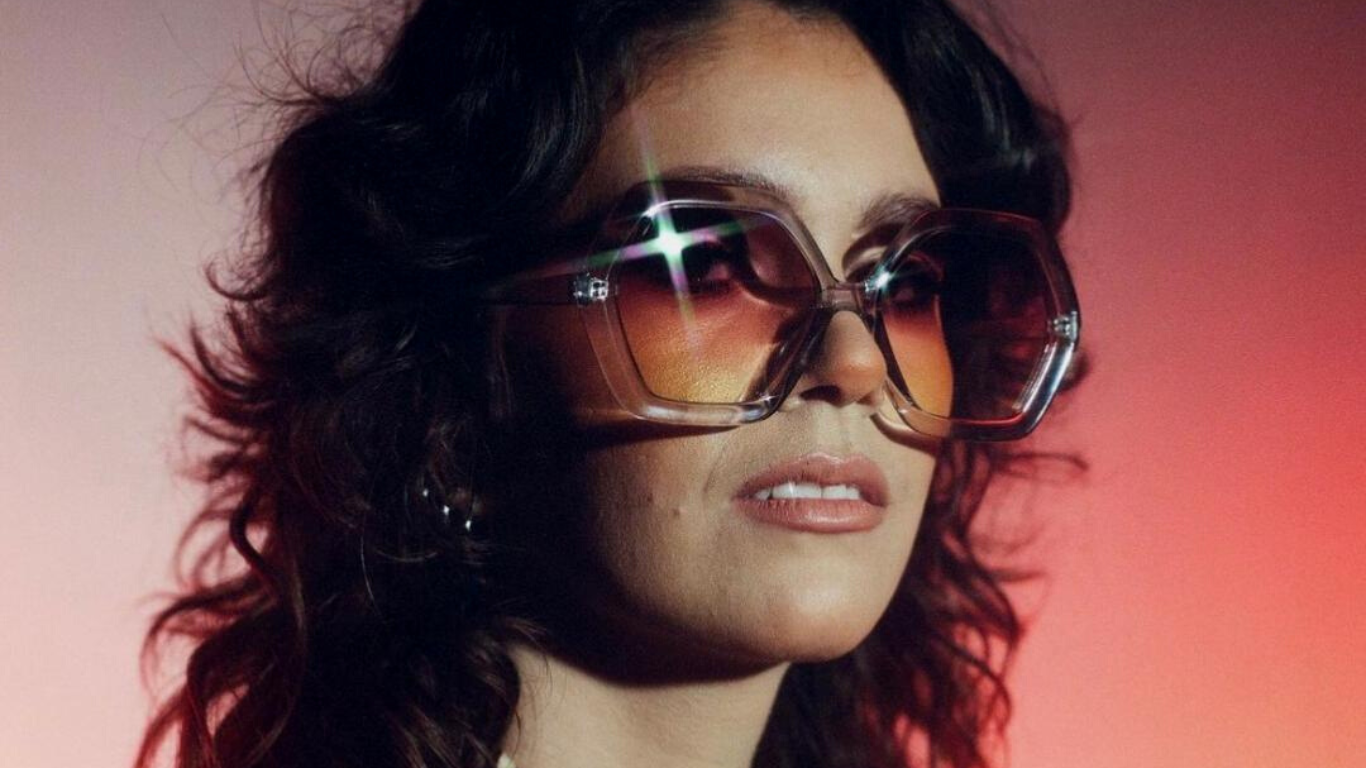 Pink purple background brunette women wearing grey octagon grey sunglasses 70s style