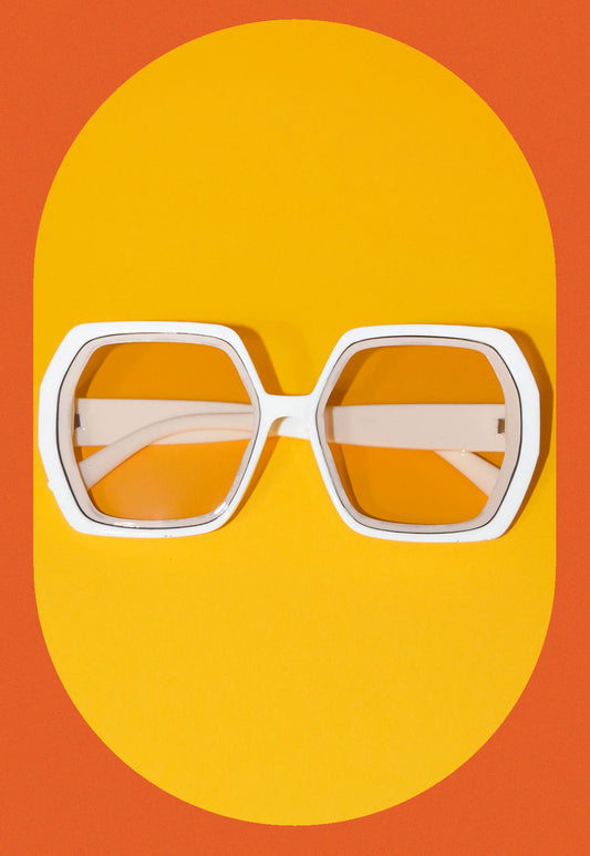 orange and yellow background and squared ivory translucent ivory sunglasses