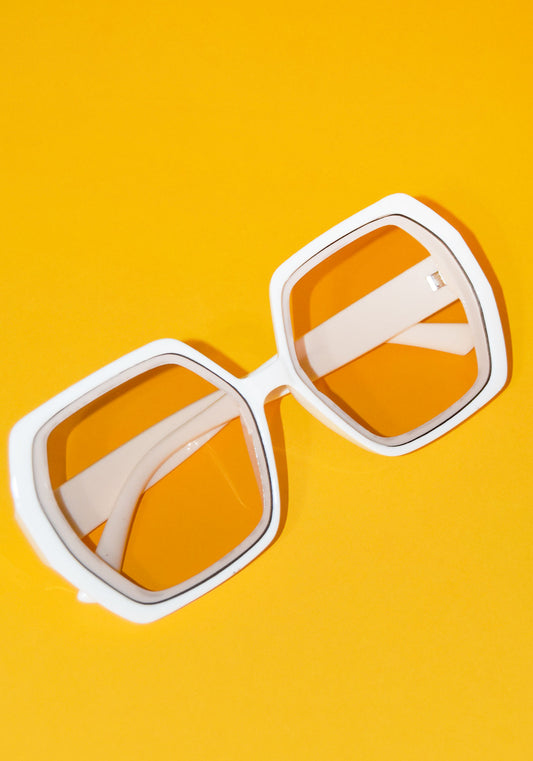 side orange and yellow background and squared ivory translucent ivory sunglasses